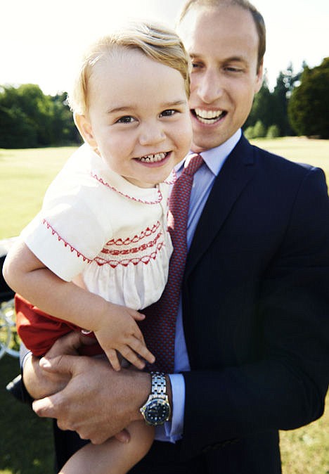 <p>In this handout image released by Kensington Palace on Tuesday July 21, 2015, Britain's Prince William holds his son Prince George following the christening of Princess Charlotte, on July 5.</p>