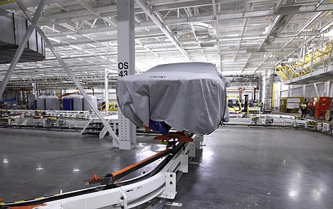 &lt;p&gt;A covered vehicle sits in part of the new paint shop at Chrysler's Sterling Heights Assembly Plant in Sterling Heights, Mich. The Commerce Department reported on wholesale prices for on Wednesday.&lt;/p&gt;