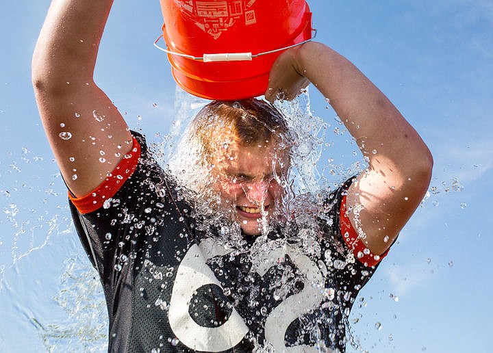 &lt;p&gt;&#160;Post Falls High School defensive end and tight end Kameron Welker grimaces while dumping ice cold water on himself during his team's ALS ice bucket challenge on Thursday on the Post Falls High School football field. The challenge raises awareness of disease.&lt;/p&gt;