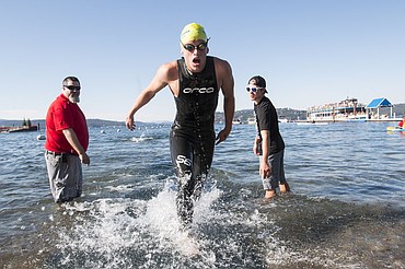 <p>Tristan Whiting finishes first at the Coeur dAlene Crossing Sunday morning with a final time of 50:56 for the 2.4 mile swim. </p>
