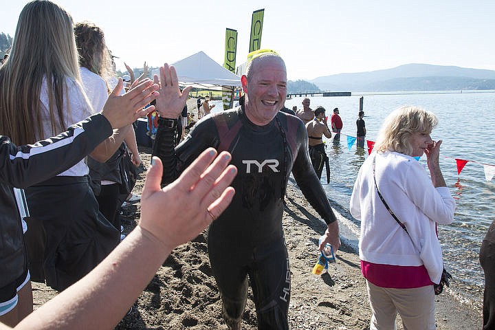 &lt;p&gt;Brian Cleary get a row of high-fives rom the North Idaho College volley ball team after completing his 2.4 mile swim across Lake Coeur d&#146;Alene.&#160;&lt;/p&gt;