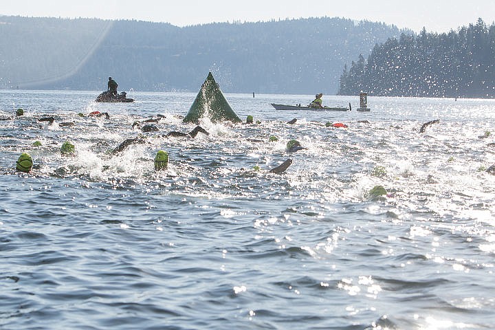 &lt;p&gt;Swimmers round the Arrow Point docks at the start of the Coeur d&#146;Alene Crossing Sunday morning.&lt;/p&gt;