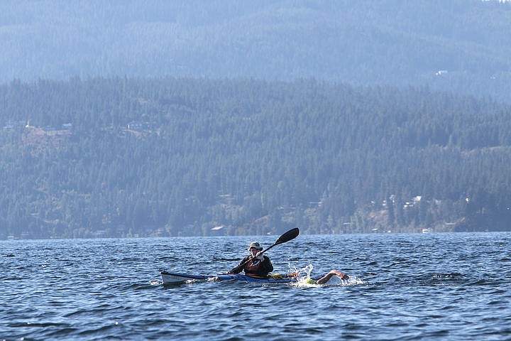 &lt;p&gt;A safety kayaker paddles next to Tristan Whiting, the top finisher of the Coeur d&#146;Alene Crossing, as he swims across Lake Coeur d&#146;Alene.&lt;/p&gt;