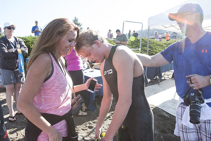 &lt;p&gt;Coeur d&#146;Alene Crossing winner Tristan Whiting leans against his mom, Samantha, after the exhausting swim.&lt;/p&gt;