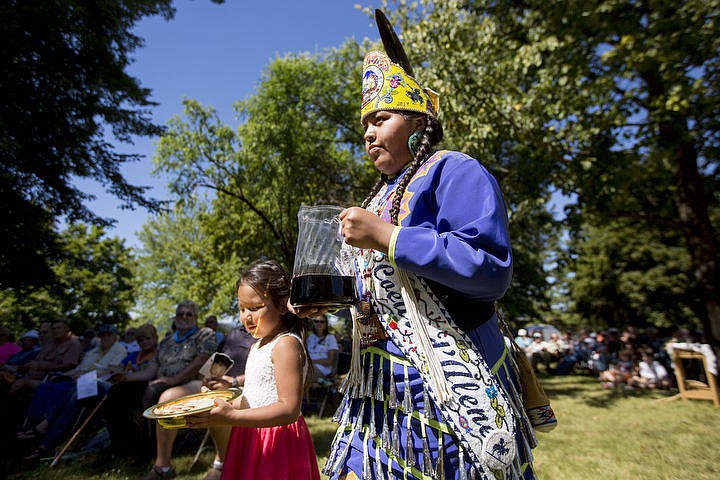 &lt;p&gt;Nikisa Arther, left, walks wine used in communion on Monday, Aug. 15, 2016 at the Coeur d'Alene Tribe's 82nd annual Cataldo Pilgrimage mass at Old Mission State Park. The Catholic mass celebrated the Feast of the Assumption of the Virgin Mary, and featured a coming together of the Catholic religion and Native American culture.&lt;/p&gt;