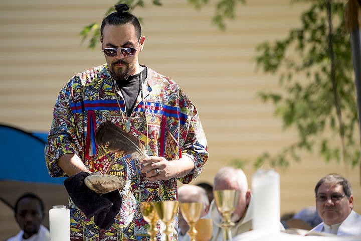 &lt;p&gt;Coeur d'Alene Tribal Member Brandon Cook waves the smoke of a smudge stick over members of the Catholic church during an incensing ceremony on Monday, Aug. 15, 2016 at the Tribe's 82nd annual Cataldo Pilgrimage mass at Old Mission State Park. The Catholic mass celebrated the Feast of the Assumption of the Virgin Mary, and featured a coming together of the Catholic religion and Native American culture.&#160;&lt;/p&gt;