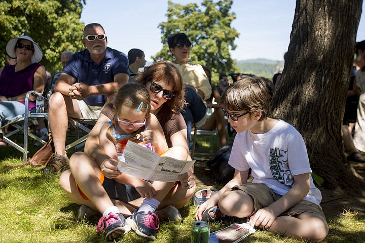 &lt;p&gt;Parker Parisot, 7, is held by her mother Anita as Paden Parisot, 11, sits next to them on Monday, Aug. 15, 2016 at the Coeur d'Alene Tribe's 82nd annual Cataldo Pilgrimage mass at Old Mission State Park. The Catholic mass celebrated the Feast of the Assumption of the Virgin Mary, and featured a coming together of the Catholic religion and Native American culture.&lt;/p&gt;