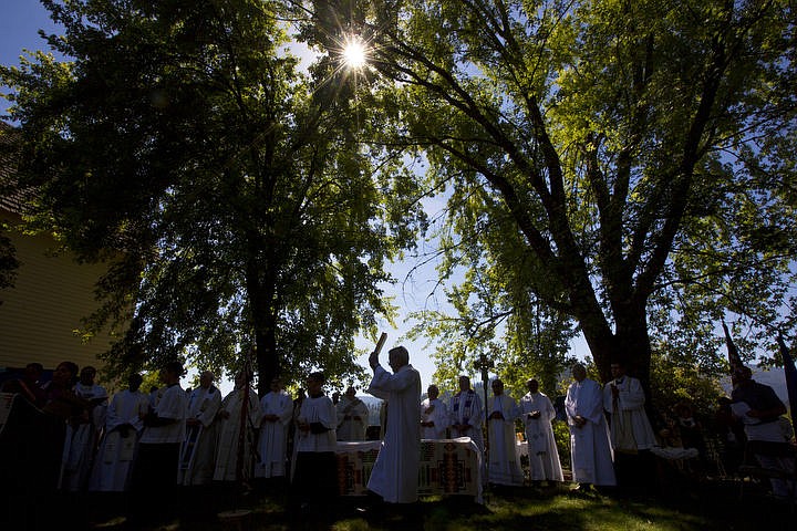 &lt;p&gt;A priest holds up a Bible on Monday, Aug. 15, 2016 at the Coeur d'Alene Tribe's 82nd annual Cataldo Pilgrimage mass at Old Mission State Park. The Catholic mass celebrated the Feast of the Assumption of the Virgin Mary, and featured a coming together of the Catholic religion and Native American culture.&lt;/p&gt;