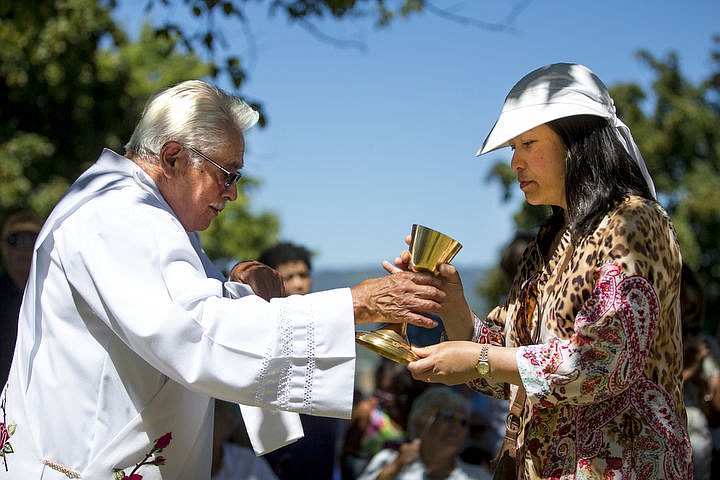 &lt;p&gt;A priest gives a mass attendee communion on Monday, Aug. 15, 2016 at the Coeur d'Alene Tribe's 82nd annual Cataldo Pilgrimage mass at Old Mission State Park. The Catholic mass celebrated the Feast of the Assumption of the Virgin Mary, and featured a coming together of the Catholic religion and Native American culture.&lt;/p&gt;