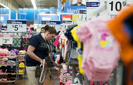 &lt;p&gt;Mary Bullen, merchandise supervisor of the infant and girls section, makes price changes to clothing at the Wal-Mart Supercenter in Rogers, Ark.&lt;/p&gt;