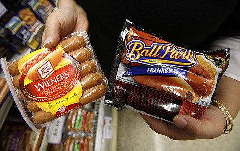 &lt;p&gt;In this May 22, 2009 photo, a store employee holds packages of Oscar Meyer wieners, a Kraft product, left, and Ball Park franks, a Sara Lee Corp. product, at a local Dahl's grocery store in Des Moines, Iowa. The nation's two largest hot dog makers are taking their legal beefs to federal court in Chicago, where a judge will determine whether either broke false-advertising laws when boasting about their top-dog status.&lt;/p&gt;