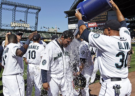 &lt;p&gt;Seattle Mariners pitcher Felix Hernandez, center, is doused with water by teammate Miguel Olivo (30) after tossing a perfect game in a 1-0 win over the Tampa Bay Rays in a baseball game, Wednesday, Aug. 15, 2012, in Seattle. (AP Photo/Ted S. Warren)&lt;/p&gt;