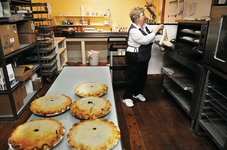 Erna Fortin puts on gloves as she prepares to check pies she is baking at the Huckleberry Patch in Hungry Horse.