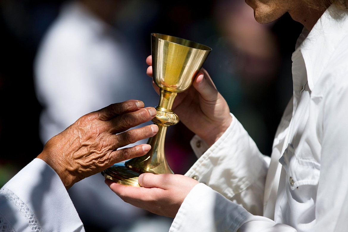 &lt;p&gt;A Cataldo Pilgrimage mass attendee, right, accepts communion from a priest on Monday at the Coeur d'Alene Tribe's annual mass at Old Mission State Park.&lt;/p&gt;