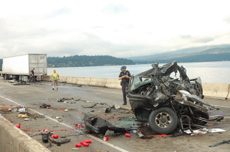 &lt;p&gt;An Idaho State Police trooper investigates the scene of a fatal crash early Friday. (Photo by DAVID KEYES)&lt;/p&gt;