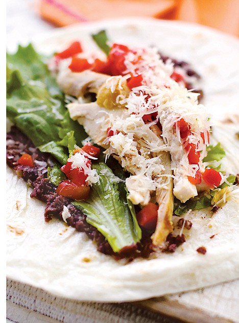 <p>This July 25, 2011 photo shows roasted chicken wraps with tapenade in Concord, N.H. Using the meat from a rotisserie chicken lends a great hefty, meaty texture to this wrap. But for convenience, deli-sliced turkey breast is a fine substitute. (AP Photo/Matthew Mead)</p>