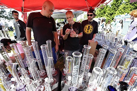 &lt;p&gt;Vendors look over their display of glass bongs at the first day of Hempfest, Friday in Seattle.&lt;/p&gt;