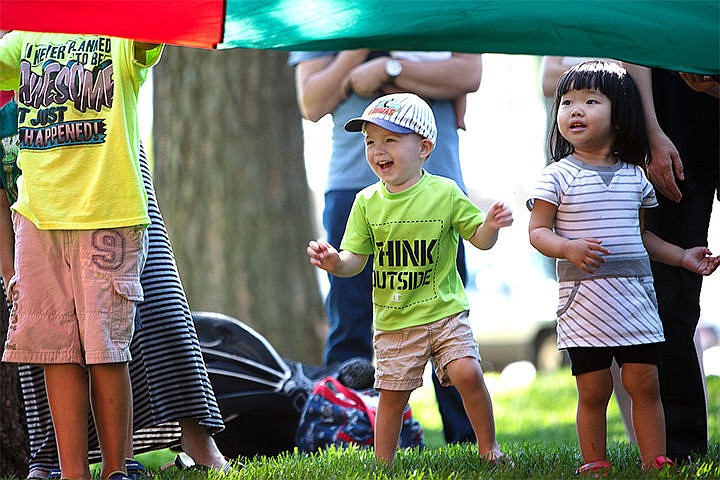 &lt;p&gt;Samuel Boggess, 2, left, and Sophie Wang, 2, look beneath a parachute balancing plastic bottles and junk Thursday at North Park in Post Falls. The kids in the group learned about the importance of recycling.&lt;/p&gt;