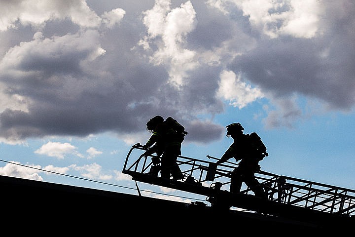 &lt;p&gt;Two firefighters with the Coeur d&#146;Alene Fire Department ascend a ladder to access the roof of the Social Security Administration building at 623 E. Wallace Avenue Tuesday after responding to a call for smoke in the building. After further inspection, no fire, smoke or damage was found.&lt;/p&gt;