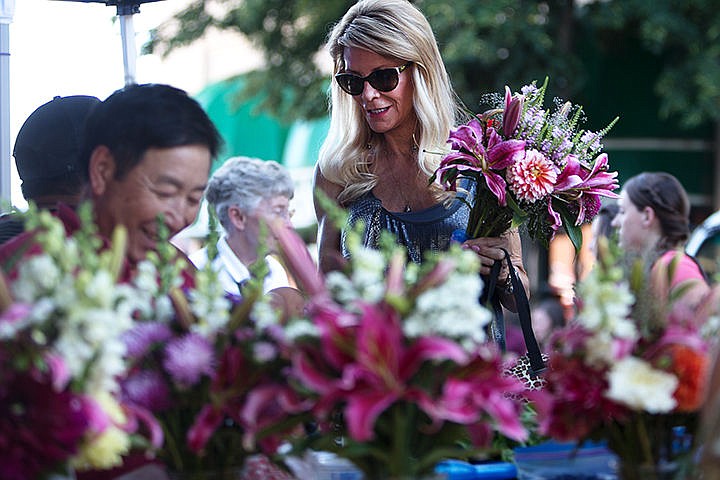 &lt;p&gt;Barbara Crumley picks out a flower bouquet Wednesday at the Farmers&#146; Market in downtown Coeur d&#146;Alene.&lt;/p&gt;