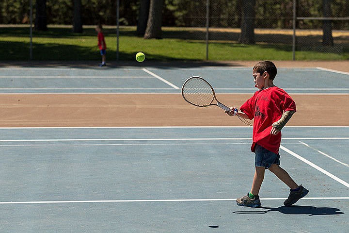 &lt;p&gt;Mason Perkins, 7, of Post Falls, concentrates on the ball while playing tennis Tuesday during Little Folks Daycamp at Ramsey Park in Coeur d&#146;Alene. Little Folks Preschool hosts various camps throughout the summer allowing children to experience several outdoor fitness activities.&lt;/p&gt;