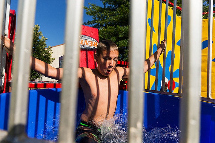 &lt;p&gt;Andrew Stockham, 11, falls into a dunk tank at the Boys Scouts of America Troop 911 booth.&lt;/p&gt;