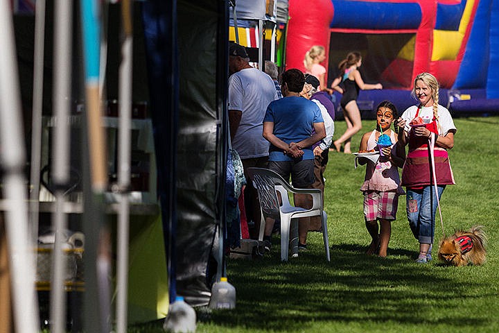 &lt;p&gt;Kristina Nicholas-Anderson, right, and her granddaughter Alyssa George, 7, check out the vendor area with snow cones in hand.&lt;/p&gt;