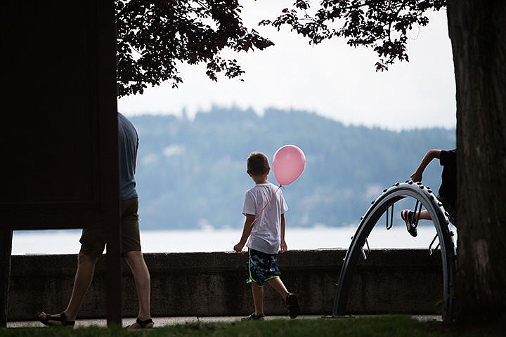 &lt;p&gt;Zain Christensen, 7, walks along the path of Coeur d&#146;Alene City Park Saturday. The 8th annual Parks Day celebration took place in the park and featured engaging activities such as a balloon giveaways.&lt;/p&gt;