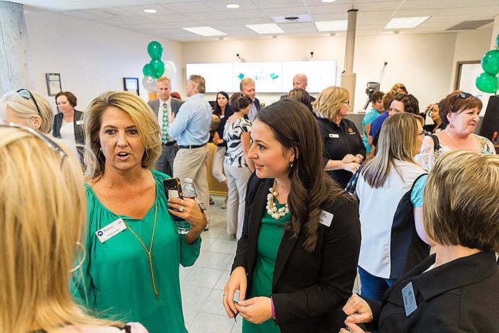 &lt;p&gt;Emily Haas, branch manager for Idaho Central Credit Union, right, and Cheryl Hunter, with Pioneer Title Co., mingle with guests during a ribbon-cutting and opening ceremony at the new Coeur d&#146;Alene bank on Thursday.&lt;/p&gt;