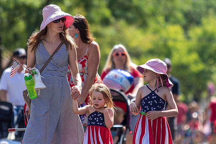 &lt;p&gt;Crystal Emry walks with daughters Nina (5), left and Natalie (2) during the annual Kids Parade down Sherman Ave. on Friday morning.&lt;/p&gt;