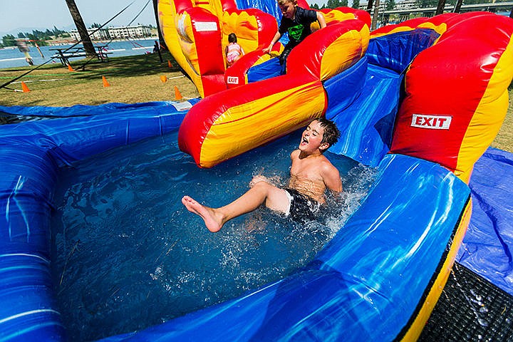 &lt;p&gt;Silas Newton, 7, of Spirit Lake, splashes into a pool at the bottom of an inflatable waterslide Friday at the Post Falls Festival at Q&#146;emiln Park.&lt;/p&gt;