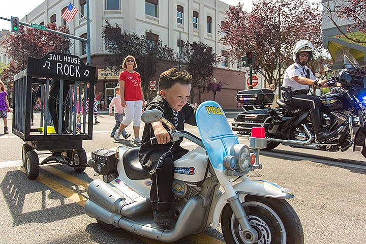 &lt;p&gt;Bentley Knoll, 4, rides his police motorcycle while towing his one-year-old brother, Carter, in a mobile jail. Police officer and father Nick Knoll rides alongside Bentley during the annual Kids Parade down Sherman Ave. on Friday morning.&lt;/p&gt;