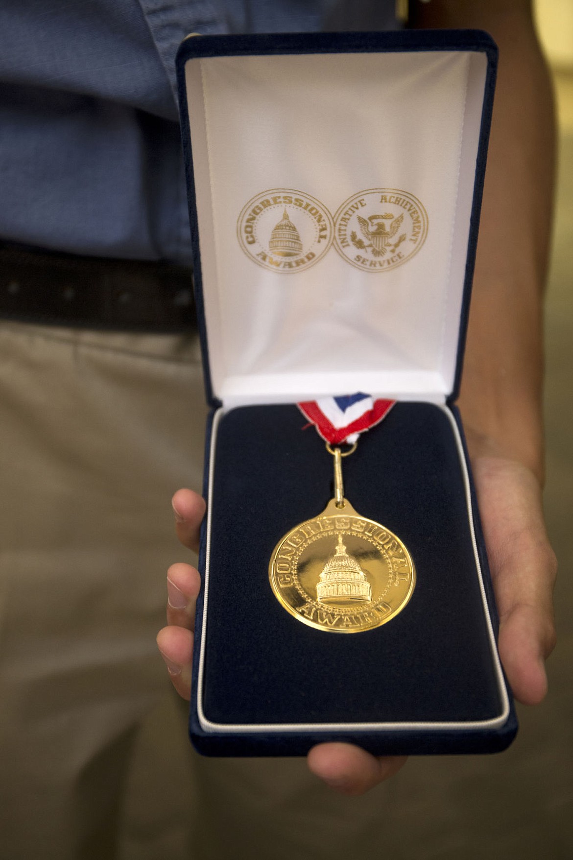 &lt;p&gt;Sam Cuentas holds his gold Congressional Award after receiving it from Congressman Labrador during a ceremony recognizing his and six other local teens volunteer efforts in the local community. The bronze, silver and gold awards require hundreds of volunteer hours in the Congressional Award Program's four areas: volunteer public service, personal development, physical fitness and expedition/exploration.&lt;/p&gt;