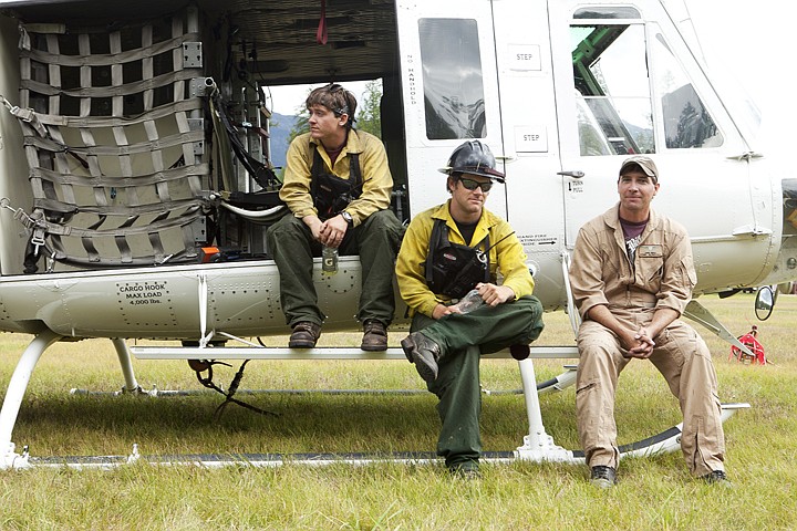 &lt;p&gt;From right to left, pilot Chris Bryce, and helicopter crew
members Bill Gage and Logan Sandman rest at the Ferndale Airfield
while waiting to be dispatched to a fire.&lt;/p&gt;