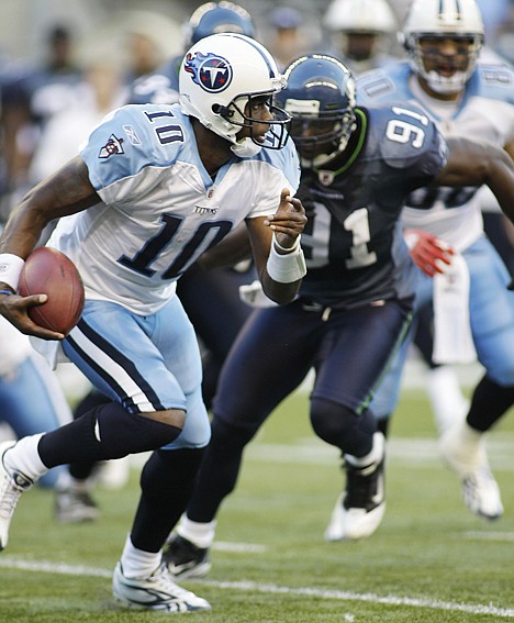 &lt;p&gt;Tennessee Titans quarterback Vince Young scrambles with the ball as Seattle's Chris Clemons closed in during Saturday's preseason game in Seattle. The Seahawks won 20-18.&lt;/p&gt;