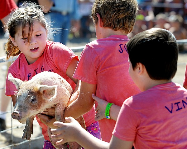&lt;p&gt;Victoria Gragg of the Pig Warriors gets help from her teammates John Bramlet, center and Vin Stevens, right, during the Pig Wrestling contest at the Northwest Montana Fair on Friday, August 16, in Kalispell. The Pig Warriors took third place.&lt;/p&gt;