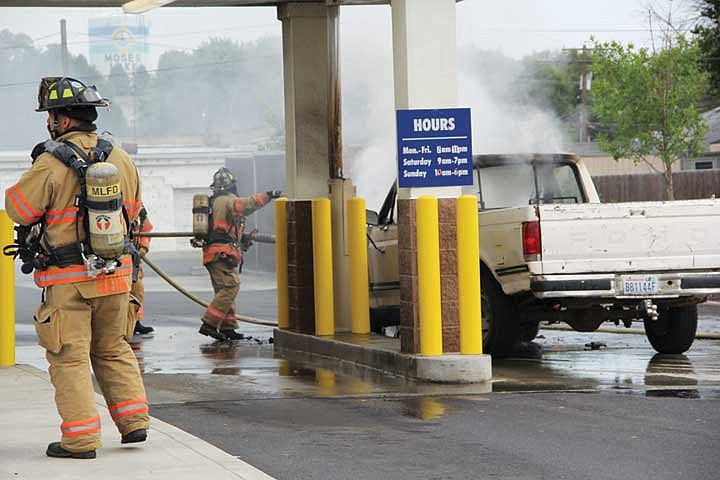 Moses Lake firefighters extinguish a pickup truck that caught fire at the Moses Lake Rite Aid Thursday afternoon.