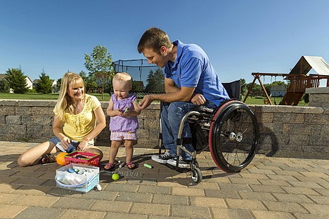 &lt;p&gt;In this photo taken Aug. 6, Brenda and Chuck Isaacson play in their back yard with their 16-month old daughter, in Sun Prairie, Wis. The VA's insurance plan covered the cost of recovering sperm but not the more than half-dozen IVF attempts the couple underwent before finally having a daughter nearly a year and a half ago.&lt;/p&gt;