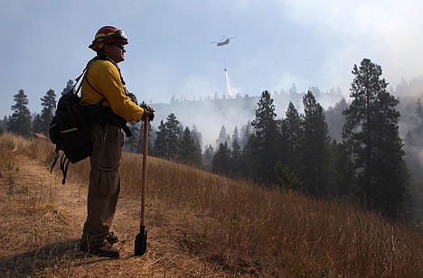 &lt;p&gt;Tracy Summers of Toledo, Wash. monitors the scene above Hidden Valley Ranch where fire crews worked to halt progression of the Taylor Bridge Fire on Thursday near Cle Elum, Wash.&lt;/p&gt;