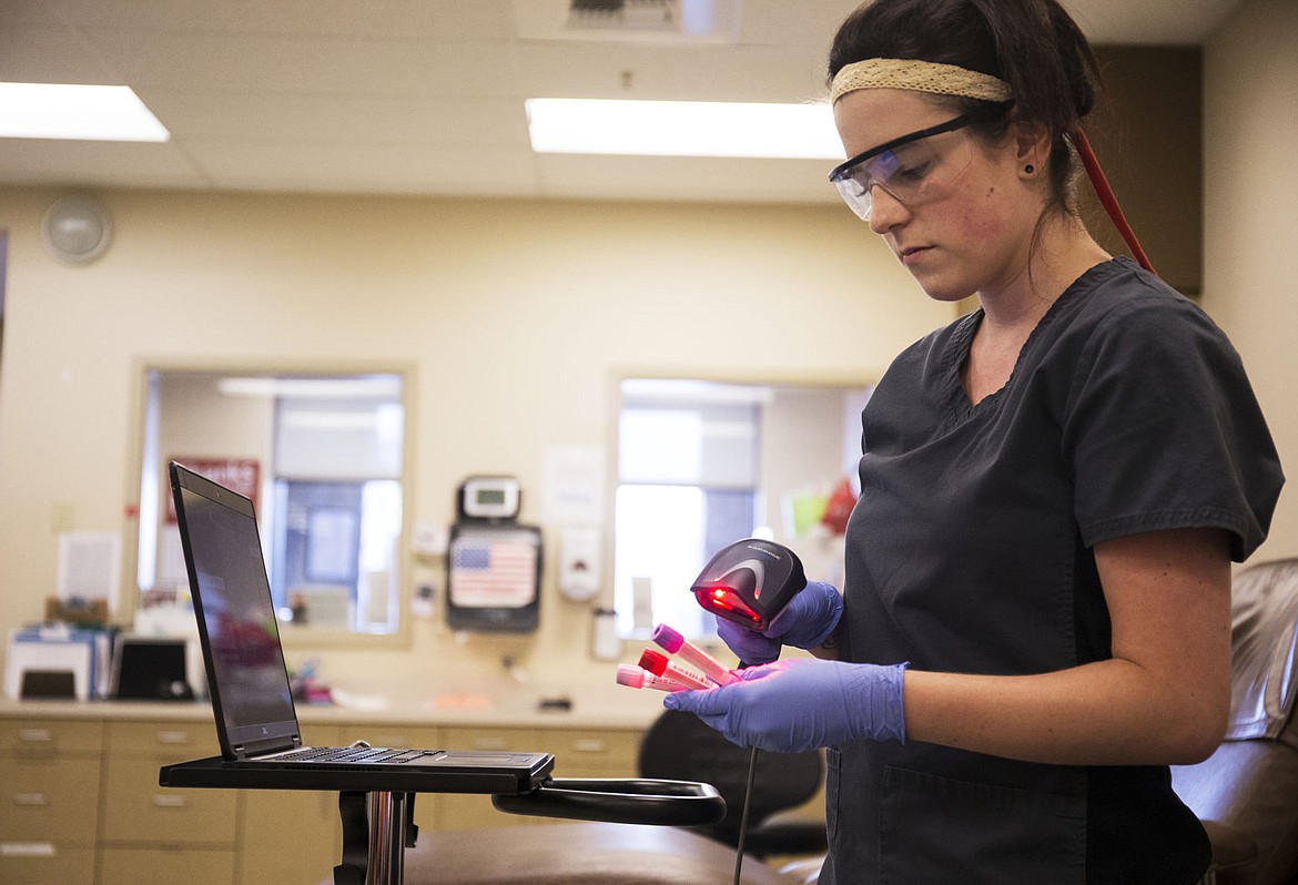 &lt;p&gt;Phlebotomist Courtney Zimmer scans a patient's blood type tube Thursday at the Inland Northwest Blood Center type before it is sent for disease testing.&lt;/p&gt;