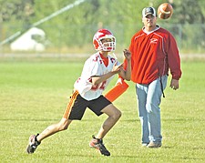 Sophomore Austin Rueble hauls in a pass in front of Arlee football head coach Scott Palmer during football practice last Friday in Arlee.