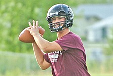 Robbie Gauthier practices throwing for the Ronan football team last Friday.