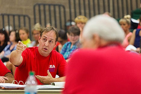 &lt;p&gt;Representing the Coeur d&#146;Alene Education Association, Tim Sanford, music teacher at Lake City High School, points to a display citing budget concerns prior to presenting an offer to the Coeur d&#146;Alene School District board of trustees Monday during a teacher contract negotiation workshop at Woodland Middle School.&lt;/p&gt;