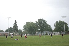 Rain didn't damper the resolve of the players at the pickup game. They just wrung out their shirts.