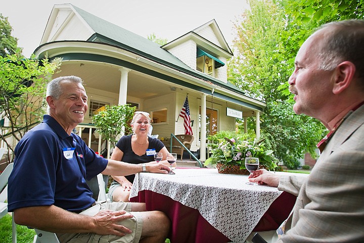 &lt;p&gt;SHAWN GUST/Press Louie Persling, left, and his wife Carla enjoy conversation and red wine with Dan Cullum Thursday during an annual dinner party at Coeur d'Alene Oral Surgery. This year Dr. Tom Walsh, who purchased the property in 1986, is celebrating the 100th anniversary of the house.&lt;/p&gt;