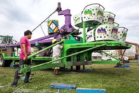 &lt;p&gt;At left, Adrian Martinez holds a support beam as Edgar Patrician attaches it to a carnival ride Tuesday at the Kootenai County Fairgrounds in preparation for this week's North Idaho Fair and Rodeo.&lt;/p&gt;