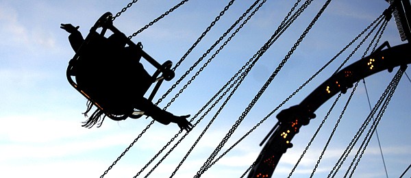 &lt;p&gt;A carnival-goer stretches out her hands, enjoying the rides at
the fair.&lt;/p&gt;