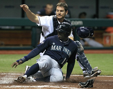 &lt;p&gt;Seattle's Trayvon Robinson (12) slides past Rays catcher John Jaso during the third inning Friday night at St. Petersburg, Fla.&lt;/p&gt;