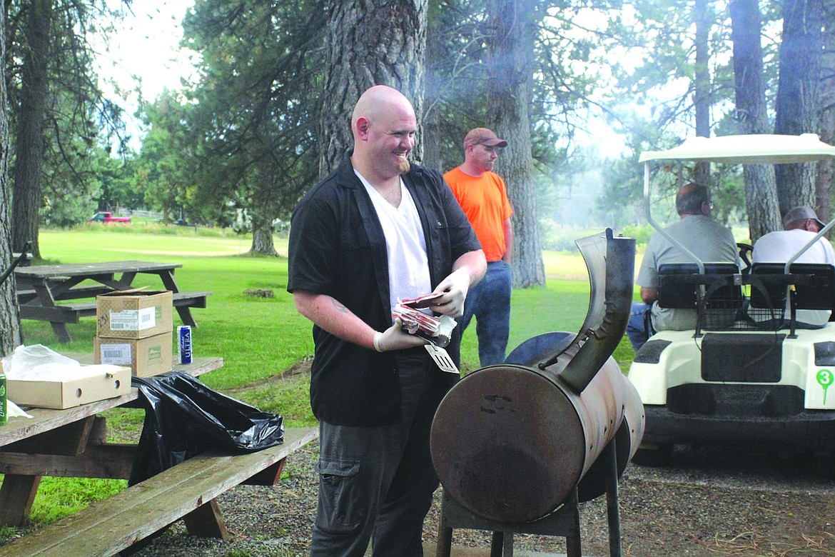 &lt;p&gt;Christopher Sankovic preps the grill for an afternoon cookout following the VFW tournament at Wild Horse Plains Golf Course.&lt;/p&gt;