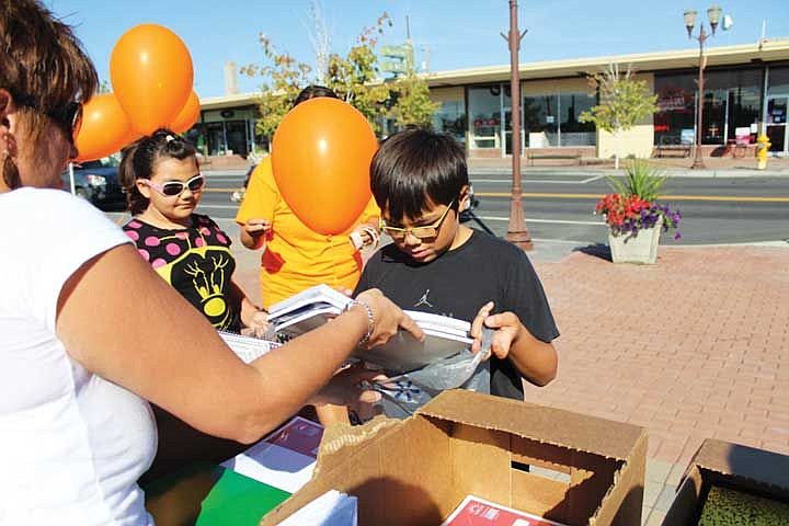 Mekhi Tillman fills his bag with school supplies at Saturday's Burst the Bug event.